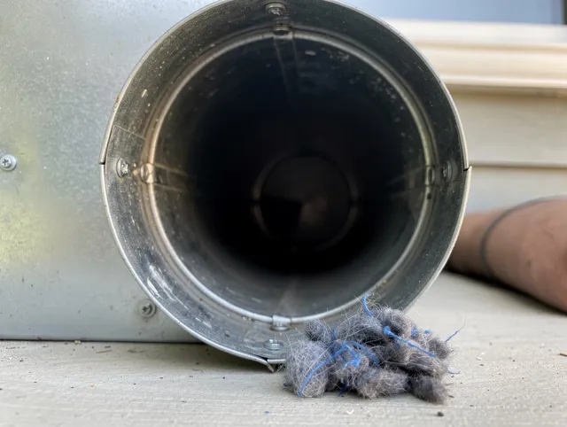 Tyngsborough Dryer Vent Cleaning technician using specialized equipment to clear severe dryer vent blockage in Tyngsborough